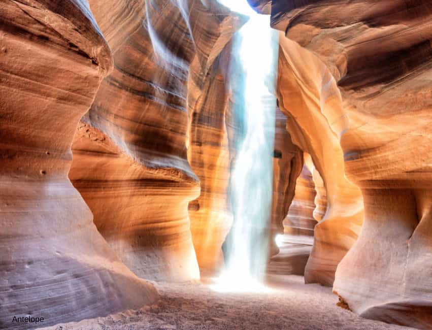 V-shaped slot canyon with a cascading waterfall in Antelope Canyon, Arizona.