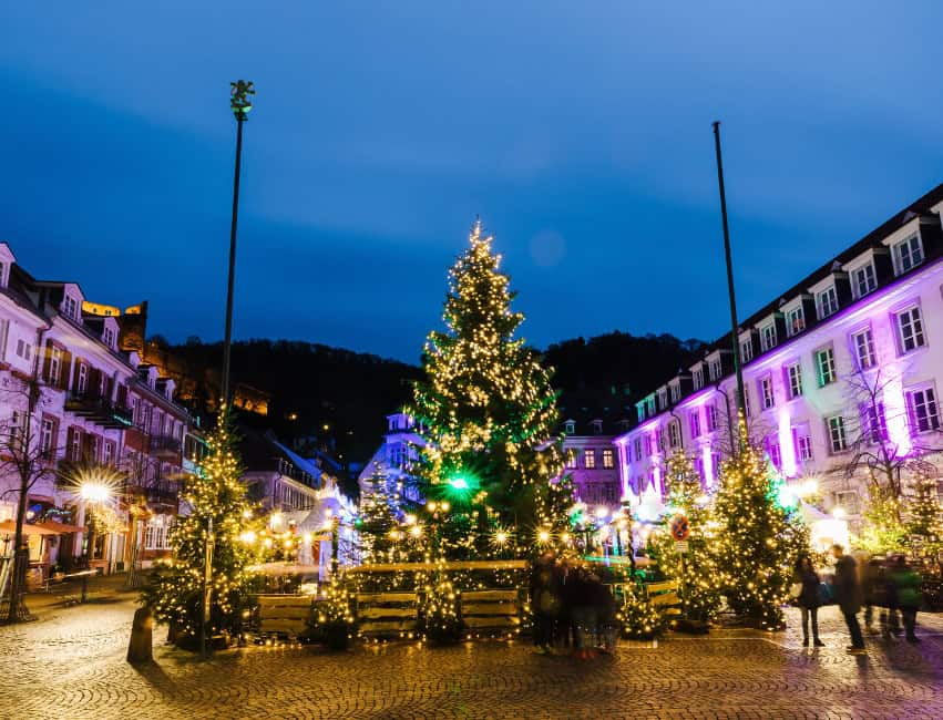Heidelberg germany best christmas markets in europe at night with golden lights and histoic buidlings in background