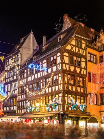 Strasbourg best christmas markets in europe at night with golden lights and histoic buidlings in background