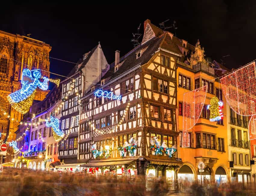 Strasbourg best christmas markets in europe at night with golden lights and histoic buidlings in background