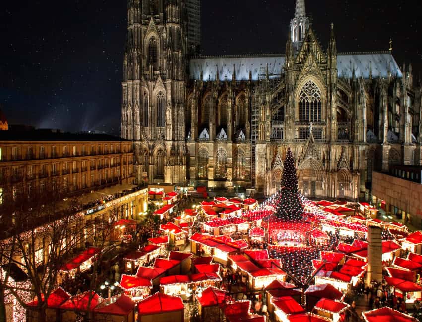 Cologne germany best christmas markets in europe at night with golden lights and histoic buidlings in background