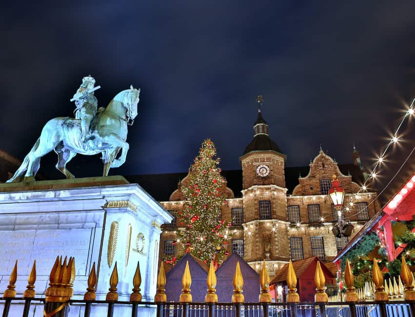 Dusseldorf germany best christmas markets in europe at night with golden lights and histoic buidlings in background
