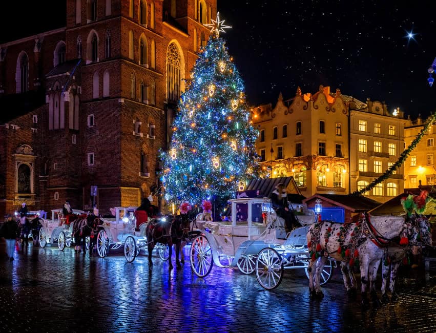 krakow best christmas markets in europe at night with golden lights and histoic buidlings in background