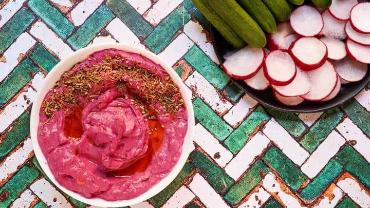Make this vibrant roasted beet hummus recipe! A healthy, vegan beetroot dip with chickpeas, tahini & lemon. Easy, colorful & perfect for parties.