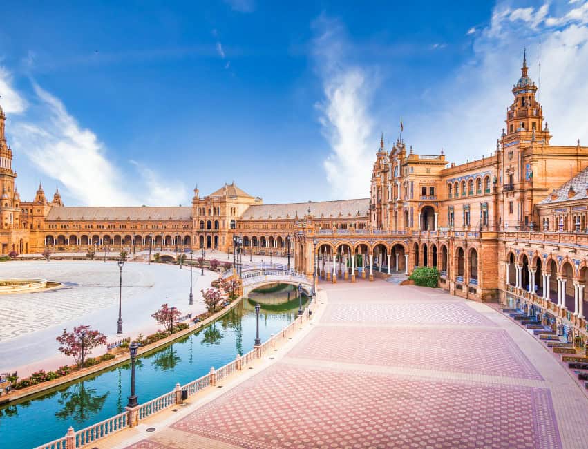 Plaza de Espa&ntilde;a in Seville, Spain &ndash; a famous landmark featuring grand architecture, fountains, and tiled bridges.