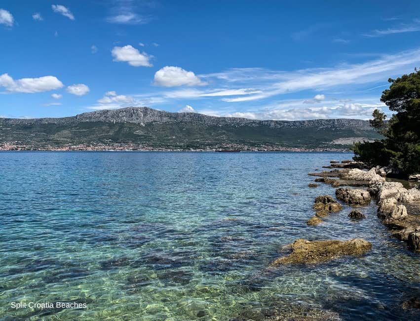 Bene Beach Split Croatia family-friendly beach shaded by pine forest with playground