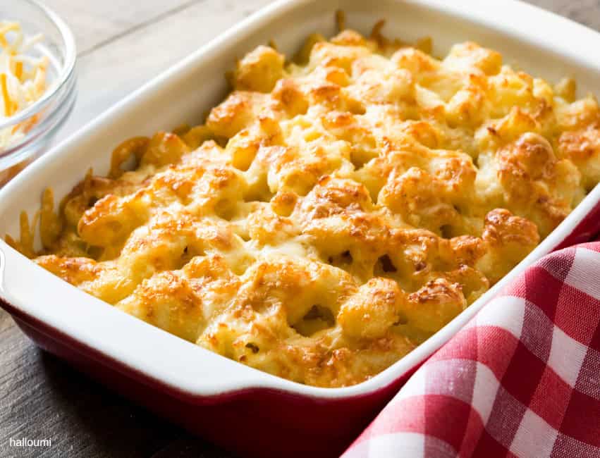 Creamy baked macaroni and cheese in a white casserole dish.