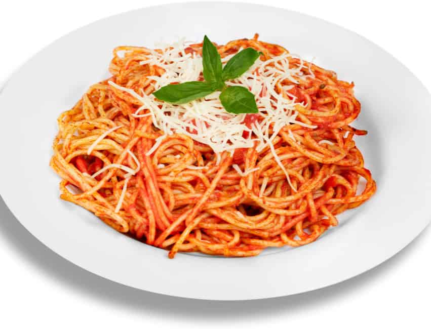 Savory spaghetti with tomato sauce, grated cheese, and fresh basil on white plate.