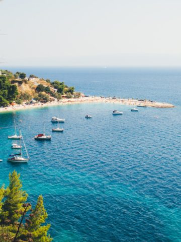 Kašjuni Beach Split Croatia pebble bay under Marjan Hill with luxury loungers and cocktail bar