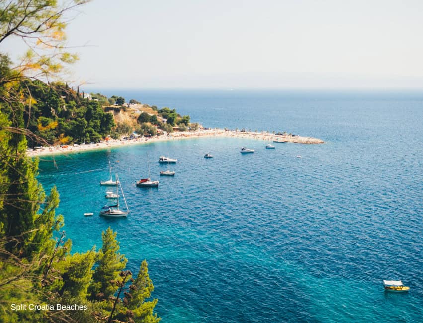 Ka&scaron;juni Beach Split Croatia pebble bay under Marjan Hill with luxury loungers and cocktail bar
