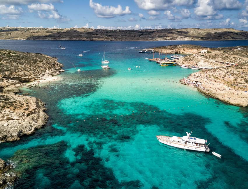 Malta scenic harbor with boats and turquoise waters beach coastal travel destination.