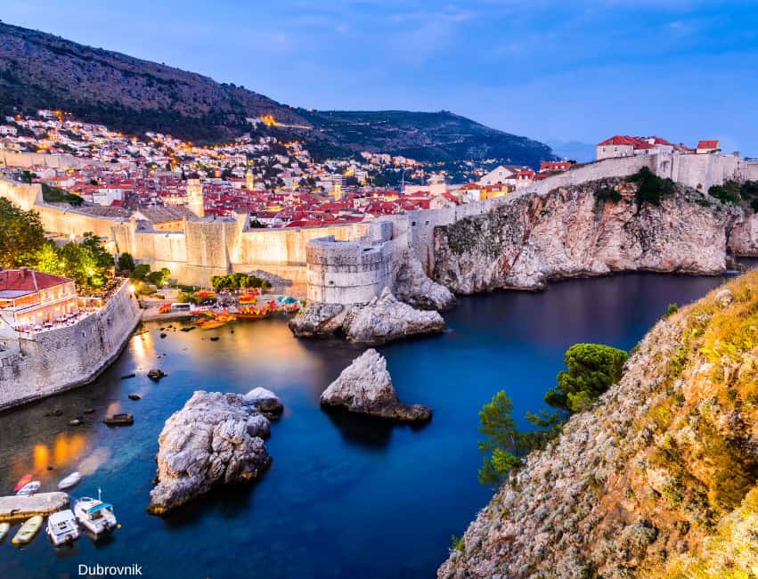 Dubrovnik Old Town with ancient city walls and stunning coastline at dusk.