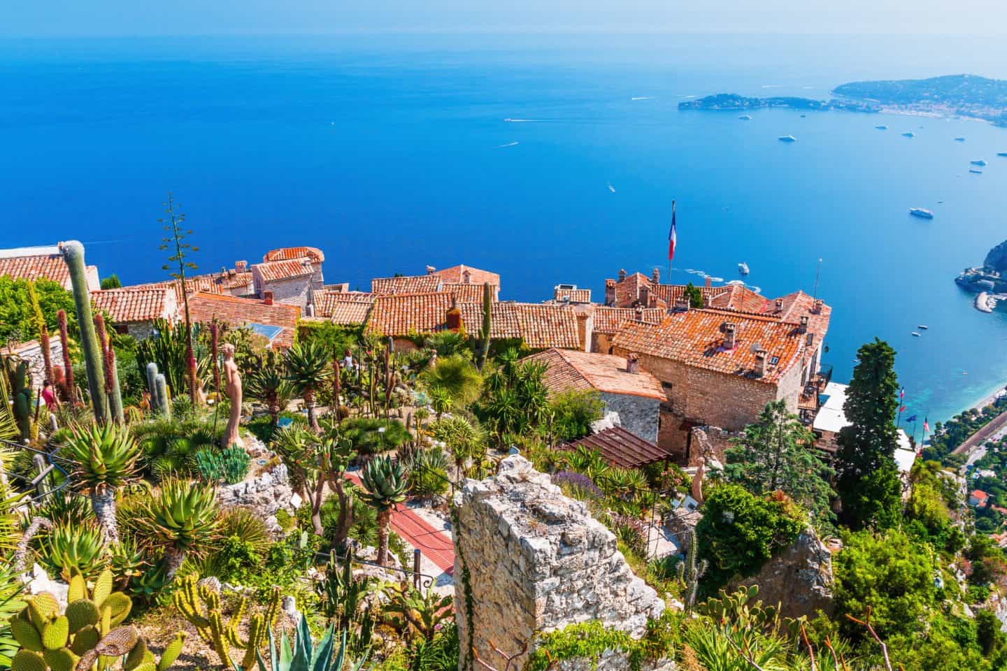 Vibrant hillside village with terracotta rooftops overlooking the Mediterranean Sea.