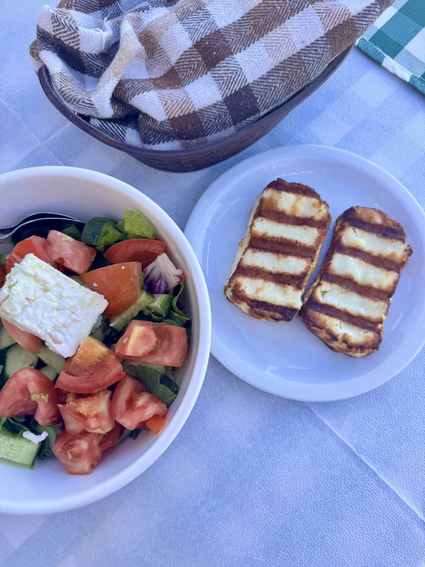 Traditional Cypriot salad with fresh tomatoes, cucumber, feta cheese, and grilled halloumi at Lysia Meat Tavern in Larnaca.