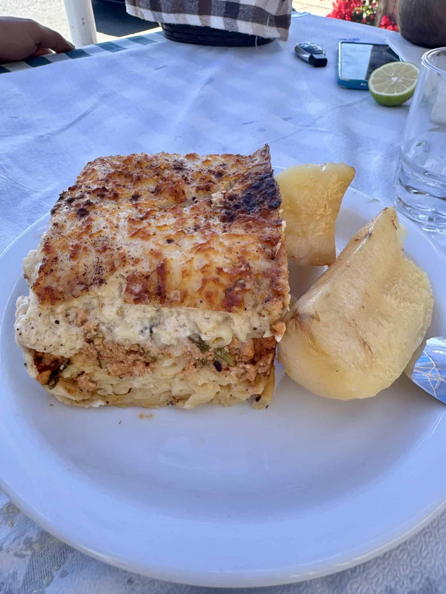 Homemade pastitsio baked with pasta, minced meat, b&eacute;chamel topping, and roasted potatoes at Lysia Meat Tavern in Larnaca.