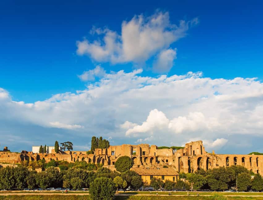 View of Palatine Hill ruins with ancient arches and gardens in Rome on a sunny winter day