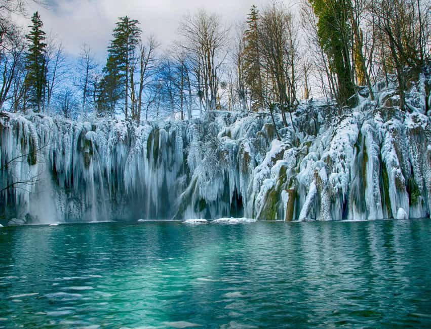 Frozen waterfalls and snowy forest in Plitvice Lakes Croatia