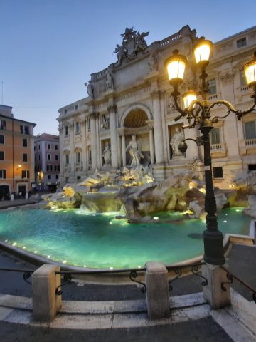 Trevi Fountain at night glowing with golden lights in winter