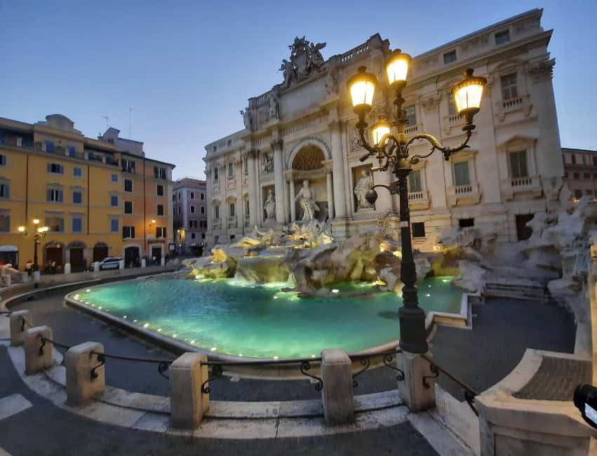Trevi Fountain at night glowing with golden lights in winter