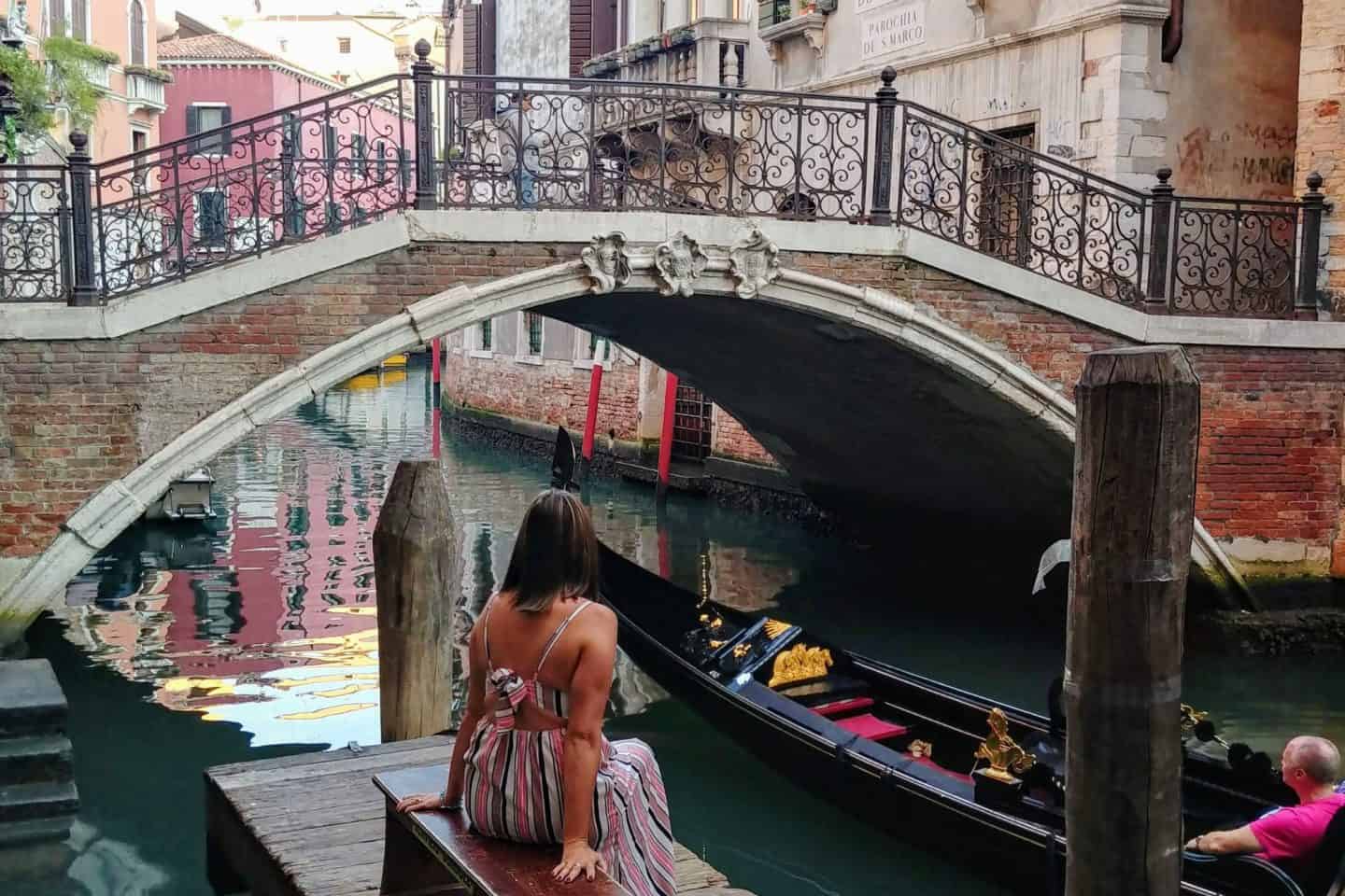 Venice canals with gondolas &mdash; romantic places to go in Italy and one of the most famous tourist spots in Italy.