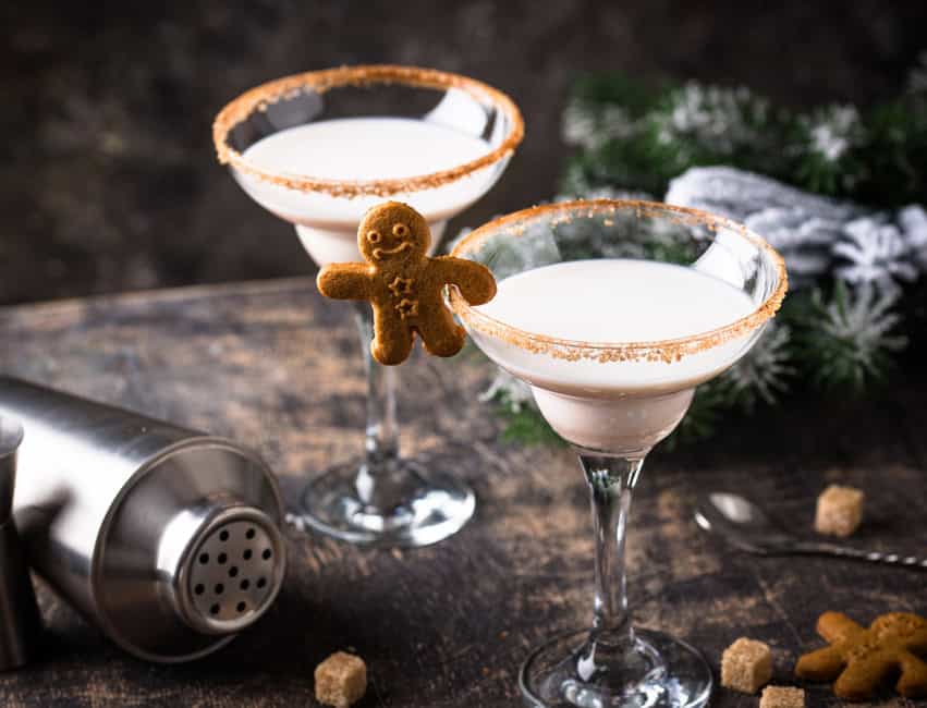 christmas cocktails martini glasses with gingerbread martini, gingebread man cookies, cocktail shaker cup