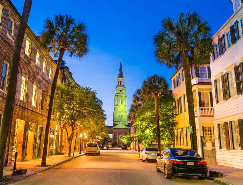 street view of charleston street with parked cars buildings and palm trees