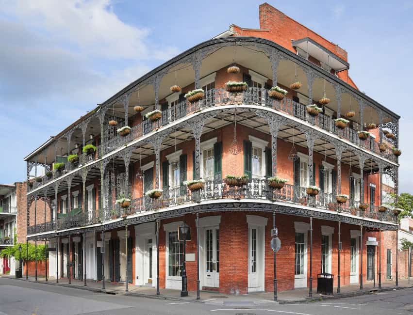 new orleans pink building with balcony and planters