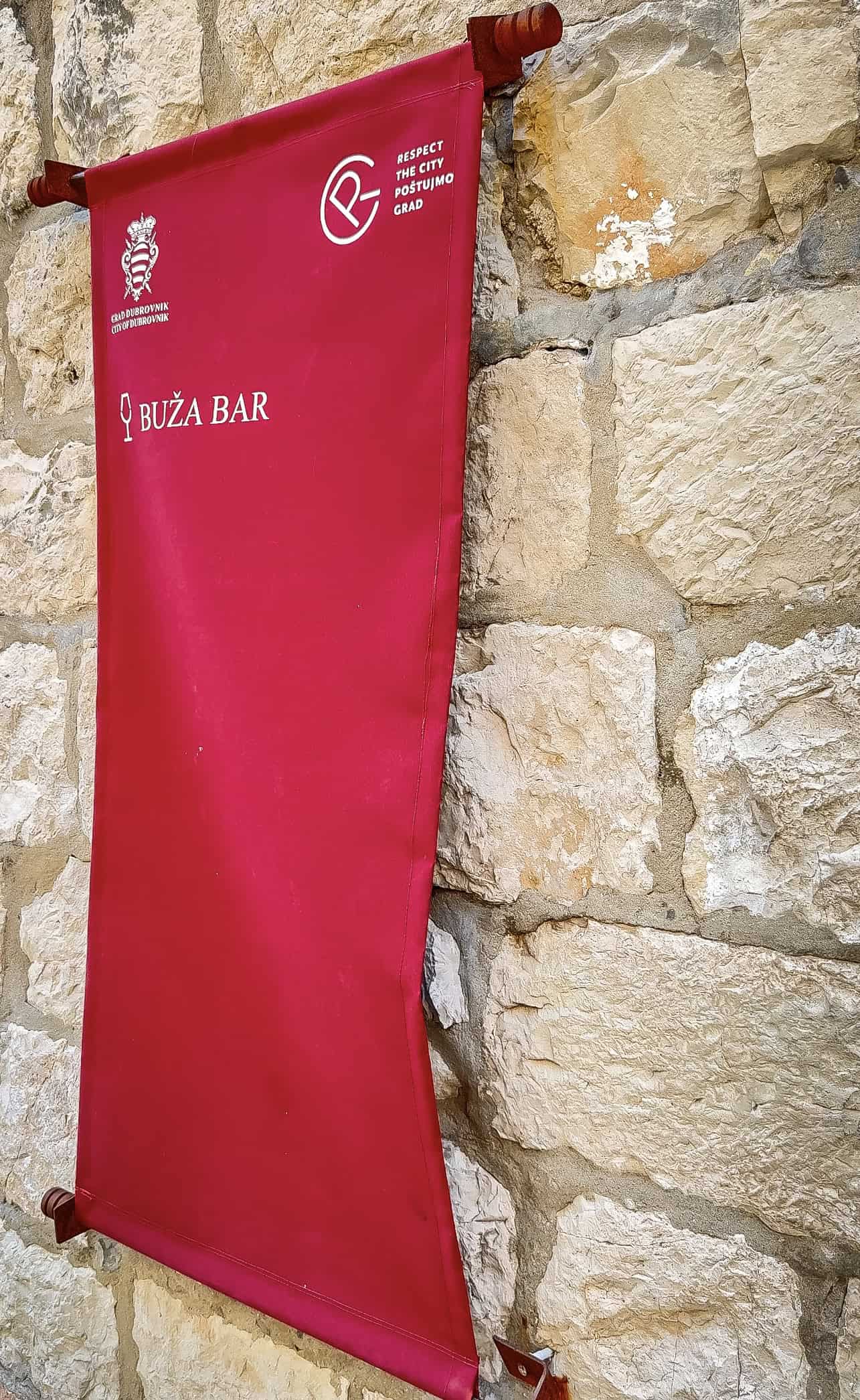 red buza bar dubrovnik sign on stone wall