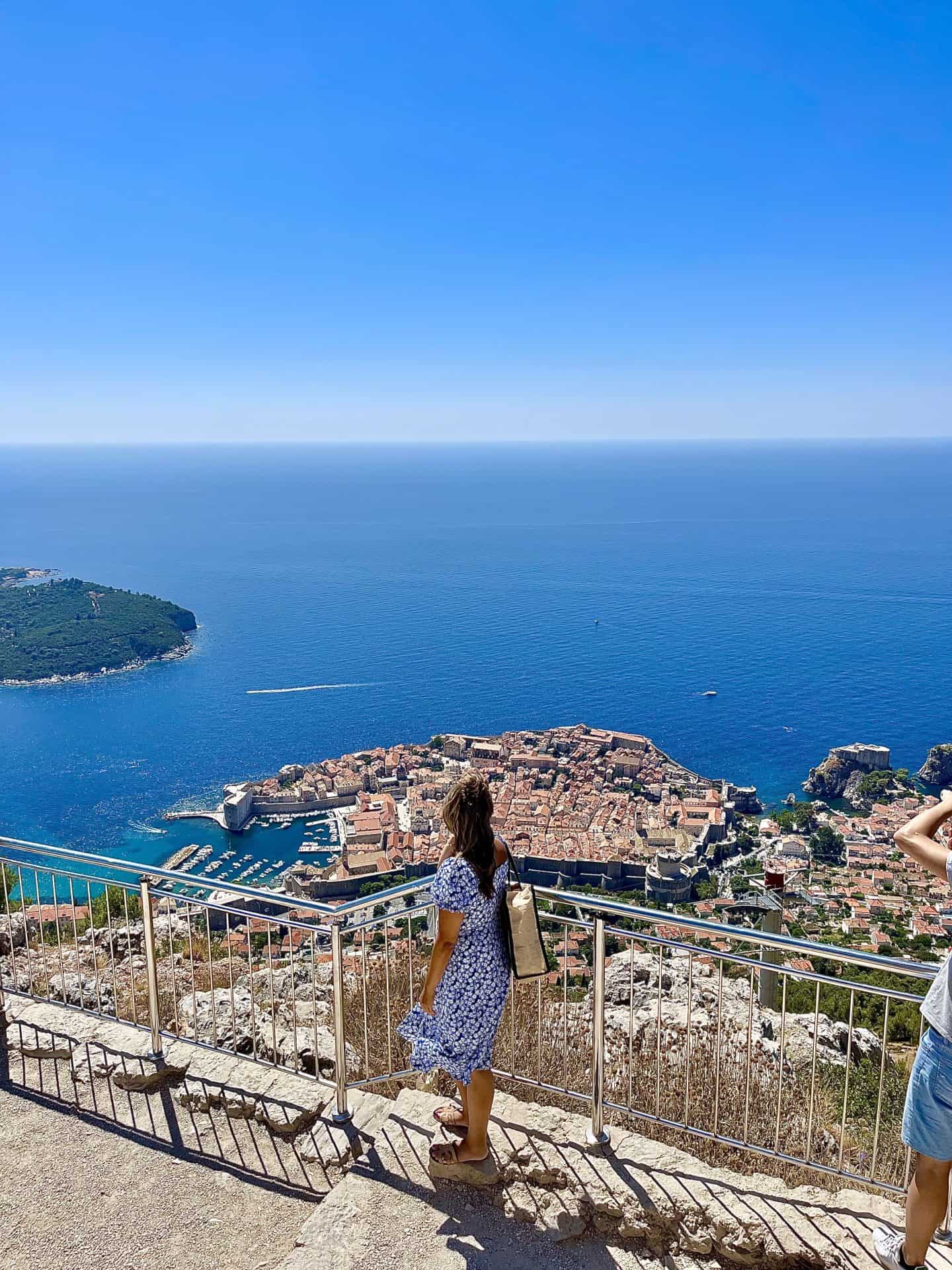 woman standing in blue dress overlooking Dubrovnik old town