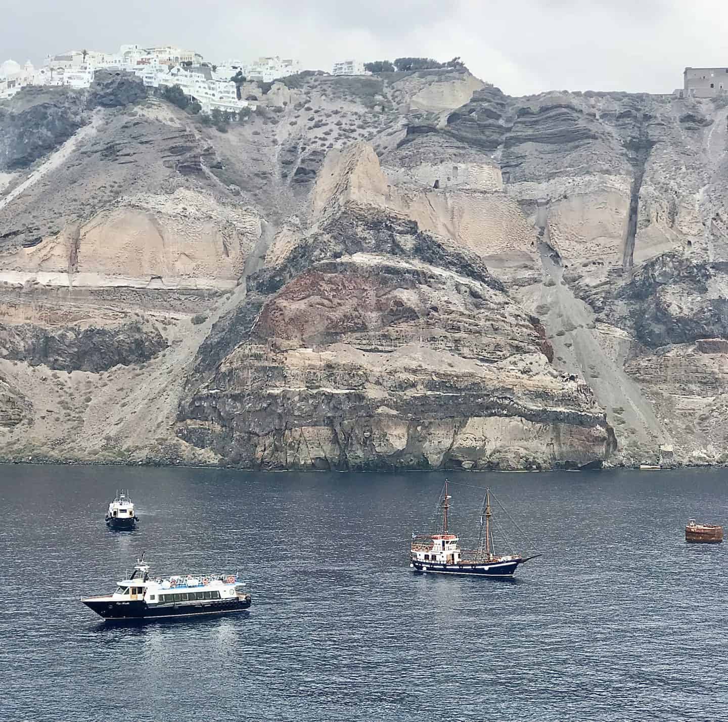 boats in oia santorini greece