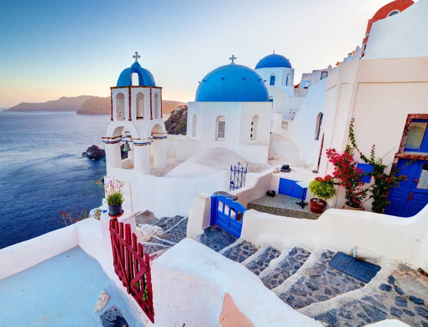 view of white buildings with blue domes in oia santorini greece