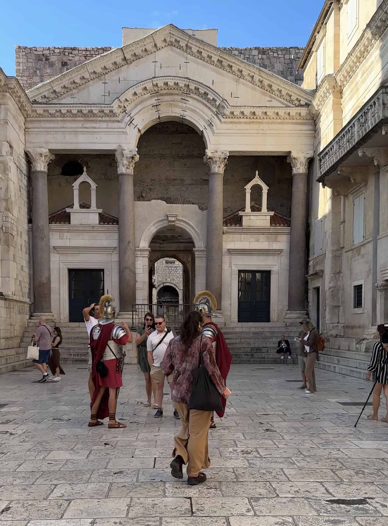 Visitors exploring the historic entrance of a Croatian church in Split. 7 days croatia itinerary